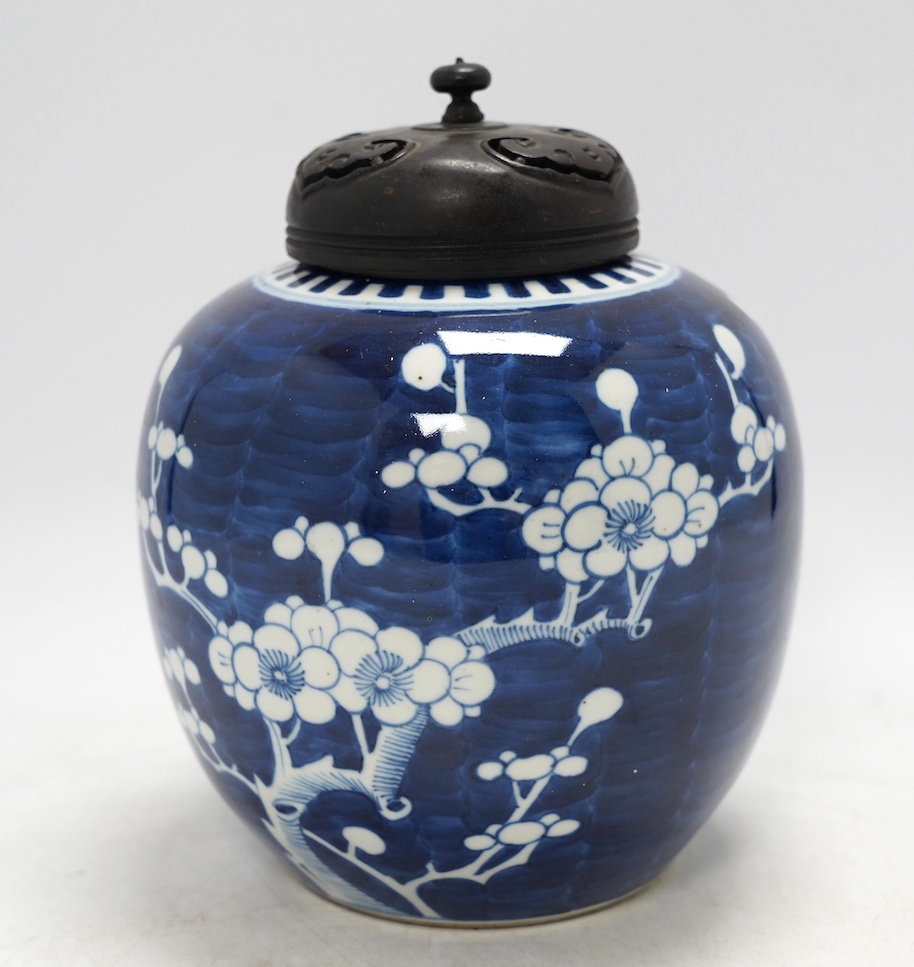 A Chinese blue and white prunus jar, with wood cover, early 20th century, 20.5cm high. Condition - good.